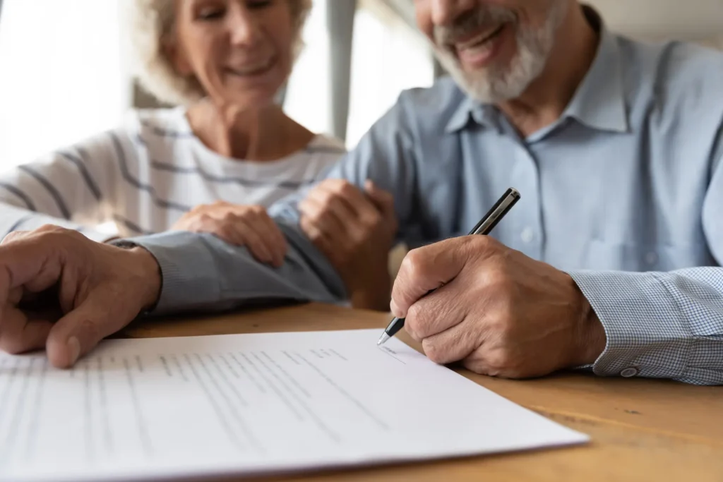 Old couple make agreement sign insurance contract